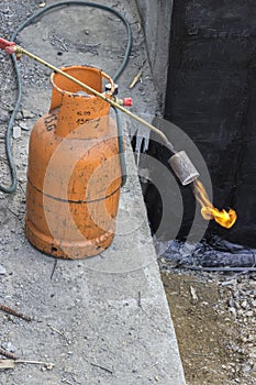 Gas cylinder with torch on flame