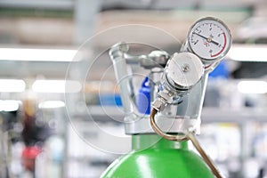 Gas cylinders with pressure gauge in a specialized laboratory