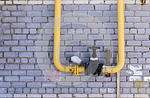 Gas equipment, pipes and shut-off valve on the background wall