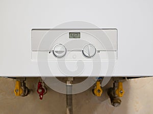 Gas-fired boiler modern water heater with control panel, temperature indicator and adjustment handles