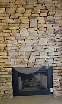 Gas fireplace insert in a natural stone wall