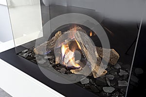 Gas fireplace with white mantel modern interior luxury design, close-up in a modern home