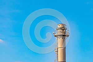 Gas flares in petroleum refinery  with blue sky background