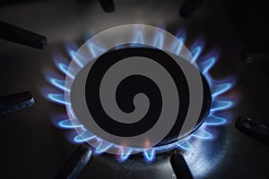 Gas hob blue flames close up