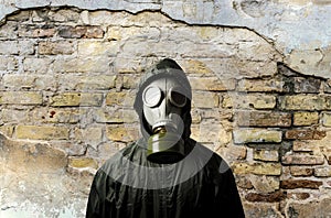 Gas mask. Man wearing a gas mask on his face and the wall behind him with copy space