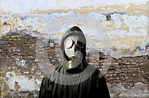 Gas mask. Man wearing a gas mask on his face and the wall behind him with copy space