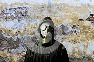 Gas mask. Man wearing a gas mask on his face and the wall behind him with copy space