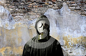 Gas mask. Man wearing a gas mask on his face and the wall behind him with copy space