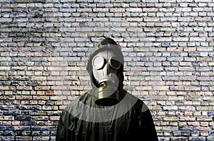 Gas mask. Man wearing a gas mask on his face and the wall behind him with copy space