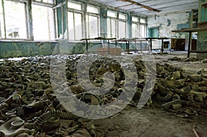 Gas masks cover the floor of an abandoned building in Chernobyl