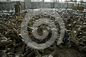 Gas masks on the floor with an old television in an abandoned middle school in Pripyat