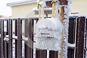 gas meter covered with snow and frost.