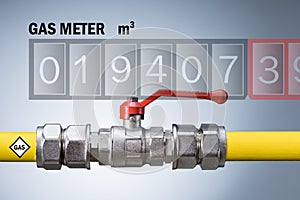 Gas meter readings and yellow gas pipe on grey background.