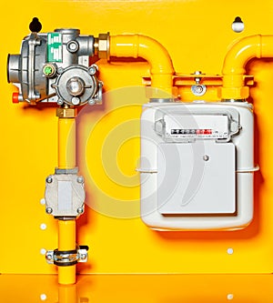 Gas meter with reducer on a yellow background