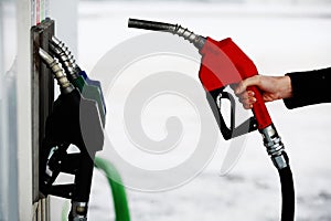 Gas nozzle in woman's hand