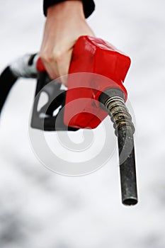 Gas nozzle in woman's hand