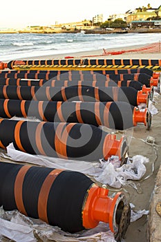 Gas or oil pipeling lying on beach