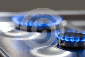 Gas Oven Concepts. Macro Shoot of Two Gas Burners on Stove Surface with Flames