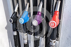 Gas and petrol station. Guns for refueling at a gas station. Detail of a petrol pump different colors in gas station. Close up on