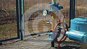 Gas pipe with manometer. Large red shut-off valve. Supply of natural gas to the public. Station for pumping and