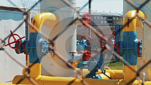 Gas pipe at the station. Pumps for pumping oil and gas. Check valves with a manometer. Storage tanks for natural gas