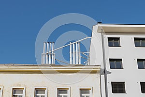 Gas pipes, exhaust and ventilation pipes on the roof of a modern residential building, drainpipes on the wall.