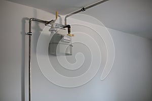 Gas pipes and meter on white wall