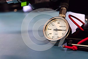 Gas pressure indicator, scuba diving oxygen lying on blue table background