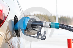 Gas pump nozzle in fuel tank of a new car
