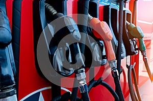 Gas pump nozzle in petrol station. Fuel nozzle in oil dispenser. Fuel dispenser machine. Refueling fill up with petrol gasoline