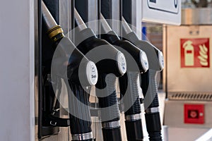 A gas pump nozzles at a gas station photo