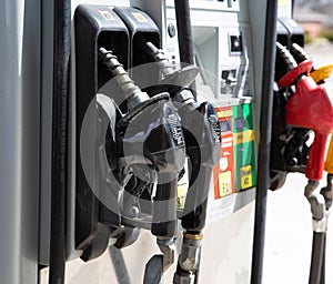 Gas pump nozzles at gasoline station