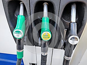 Gas pump nozzles (hoses) at gas station in the Netherlands. Gasoline prices are still very high