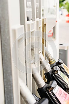 Gas pump nozzles in service station. Benzine