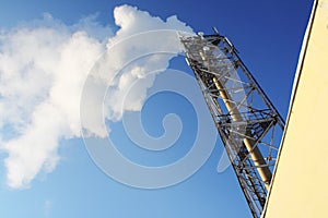 Gas. Smoke leaving a pipe. On blue sky