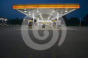 Gas Station with lights on and mini-mart at dusk in Central GA