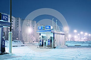 Gas station at night city lights of winter