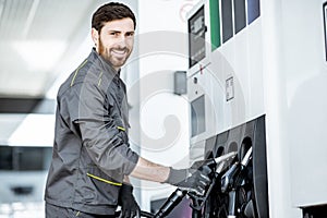 Gas station worker refueling car