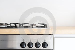 Gas stove and control panel of electric oven at modern kitchen