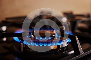 Gas stove with flame on burner, close up