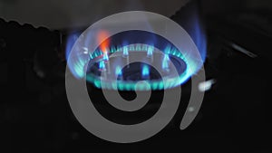 Gas stove, the flame is ignited. Slow motion video close up. The concept of gas blackmail.