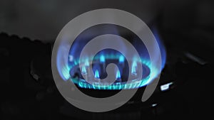 Gas stove, the flame is ignited. Slow motion video close up. The concept of gas blackmail.