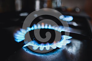 Gas stove, gas flame. Gas in the kitchen. Natural gas shortage. Defocused