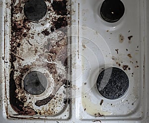 Gas stove in the mud. four gas burners are smeared. dirt on the stove. Dirty stove in the kitchen.