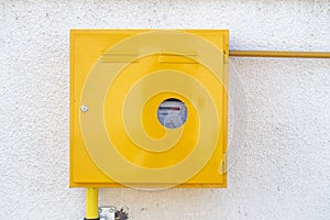 Gas supply meter on wall outside mounted cabinet