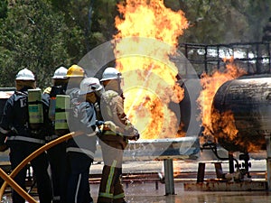Gas tank on fire with Emergency Fire Fighters photo
