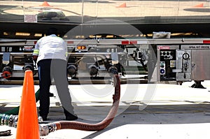 Gas tanker worker checking the valves