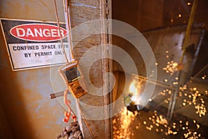 Gas tester detector atmosphere hanging at confined space entry and exit man hole door continue monitoring photo