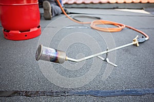 Gas torch and bottle on a flat roof