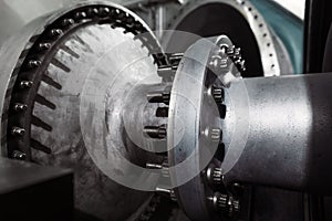 A gas turbine with a compressor rotor and a bolted coupling half